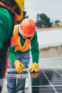 Worker installing solar panels.